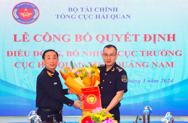 Phó Tổng cục trưởng Hoàng Việt Cường (trái) trao quyết định bổ nhiệm và tặng hoa chúc mừng tân Cục trưởng Cục Hải quan Quảng Nam.