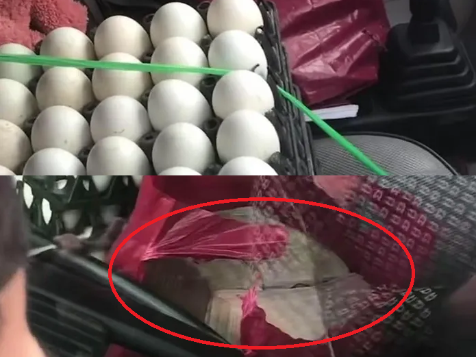 Người phụ nữ đi giao trứng bất ngờ khi thấy nam thanh niên ném túi tiền vào xe (Hình ảnh lan truyền trên mạng xã hội).