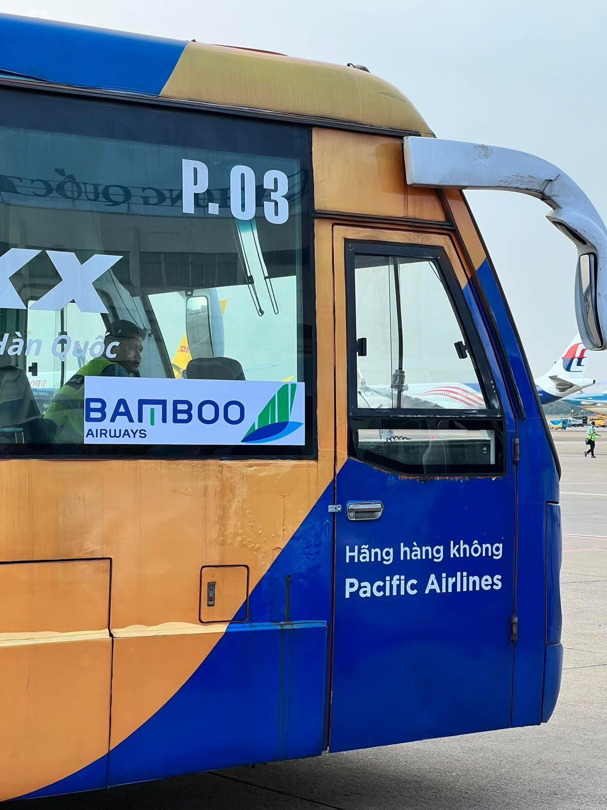 Xe cobus của Pacific Airlines vận chuyển hành khách của Bamboo Airways ngoài sân đỗ