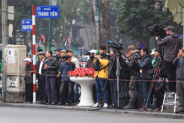 Lực lượng ph&oacute;ng vi&ecirc;n chờ đ&oacute;n thời điểm đo&agrave;n xe chở &ocirc;ng Kim Jong-un đi qua.