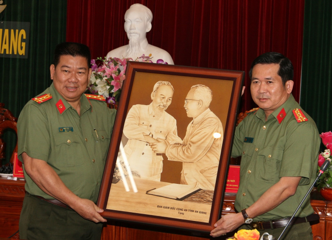 Đại tá Đinh Văn Nơi – Giám đốc Công an tỉnh An Giang (bìa phải) trao quà lưu niệm cho lãnh đạo Công an thành phố Cần Thơ