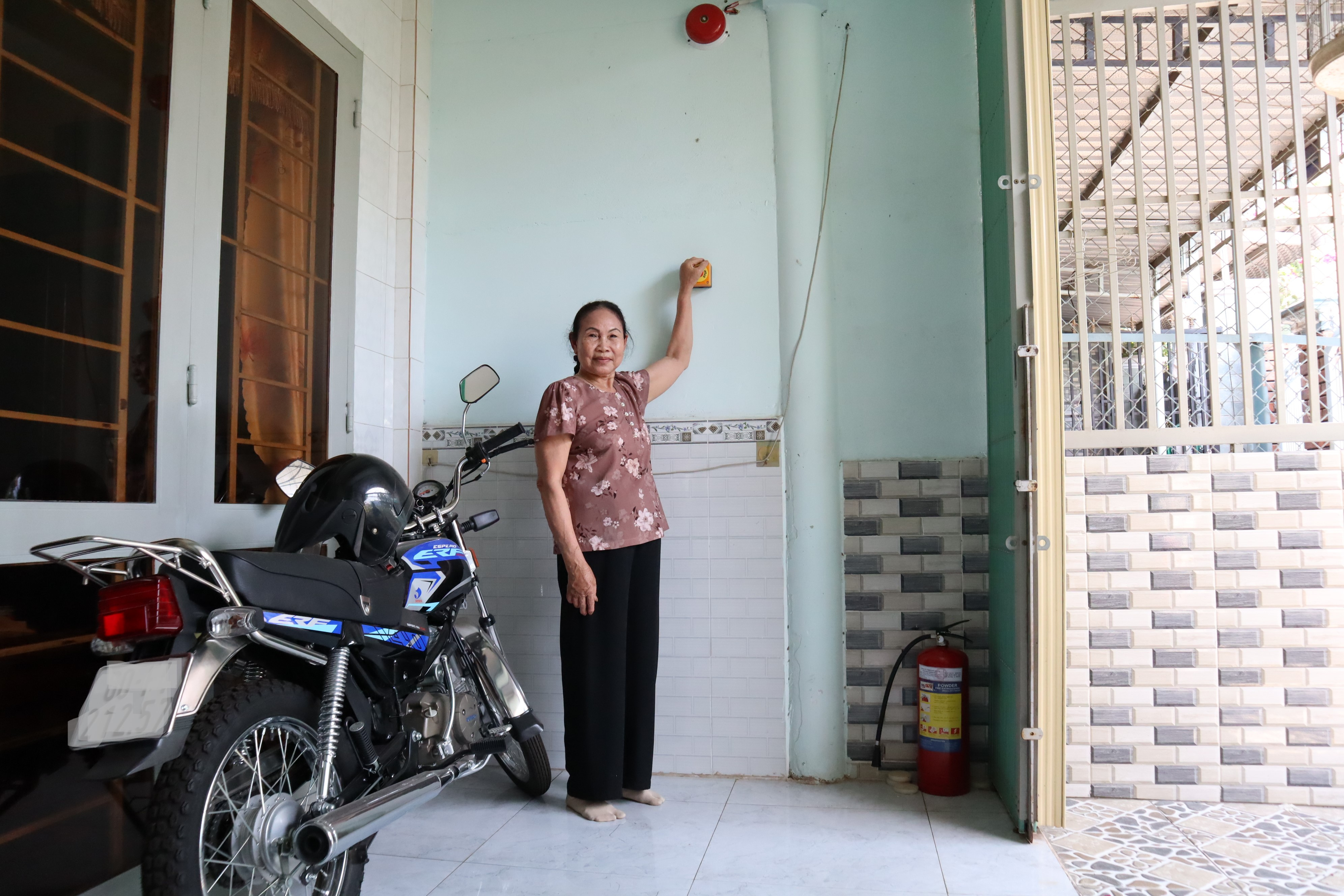 chiếc chuông báo cháy được đặt ở vị trí vừa tầm với của mọi người trong hộ nhà bà Phạm Thị Nguyệt Nga.
