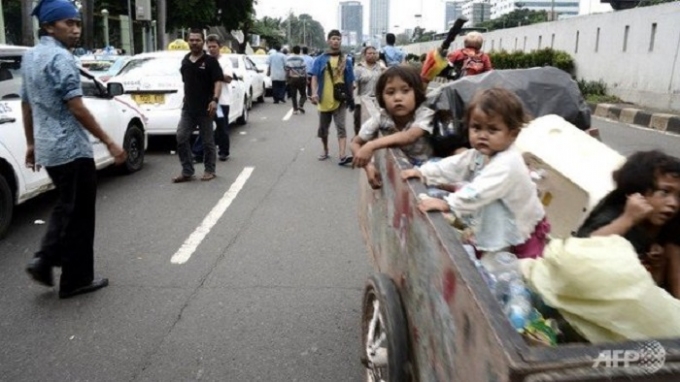 Trẻ em bị b&oacute;c lột sức lao động được chở tr&ecirc;n xe chứa r&aacute;c. (Theo AFP)