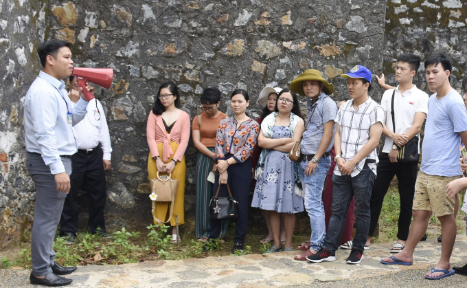 2 (6) (1)Thuyết minh viên Trung tâm Bảo tồn Di tích Quốc gia Côn Đảo hướng dẫn du khách tham quan trại giam Phú Tường. (ảnh: Báo BRVT)