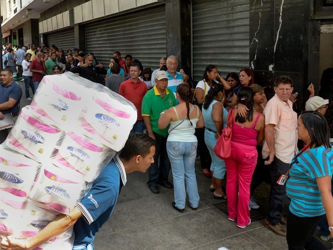 Người d&acirc;n Venezuela xếp h&agrave;ng để mua đồ d&ugrave;ng thiết yếu (Ảnh: Reuters).