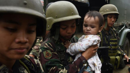 Qu&acirc;n đội Philippines đưa trẻ em tới nơi an to&agrave;n trong cuộc xung đột tại Marawi. (Ảnh: T.A)