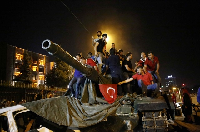 Người d&acirc;n đứng tr&ecirc;n một xe tăng qu&acirc;n đội ở Ankara (Ảnh: Reuters)