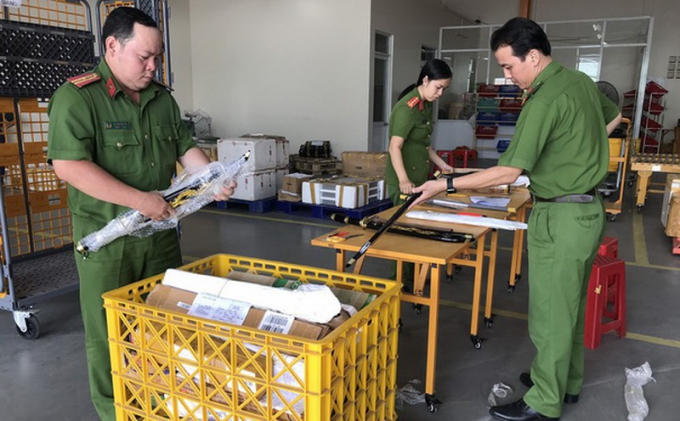Lực lượng chức năng tháo kiểm tra các gói bưu phẩm chứa vũ khí, công cụ hỗ trợ.