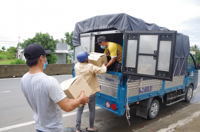 Hàng hóa được bốc dỡ sang một chiếc xe tải trước khi được áp tải vào thành phố Bạc Liêu (Ảnh: Văn Đông).