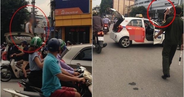 Hà Nội: Tài xế taxi "ăn vạ" trên nóc xe, xuất trình giấy bị phơi nhiễm HIV
