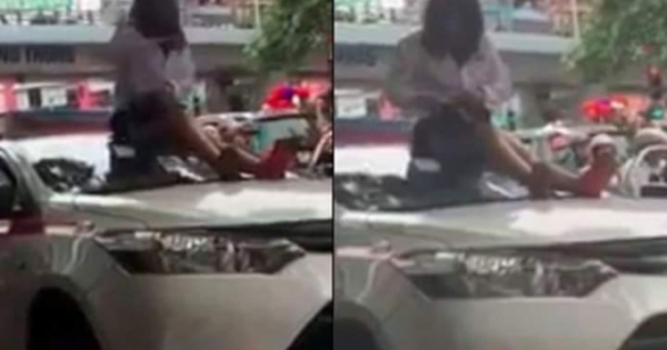 Bị CSGT dừng xe, nữ tài xế taxi trèo lên nóc xe ăn vạ