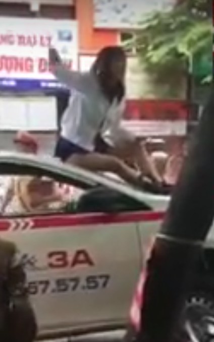 H&agrave; Nội: Nữ t&agrave;i xế taxi mặc v&aacute;y, ngồi n&oacute;c &ocirc; t&ocirc; chống đối CSGT