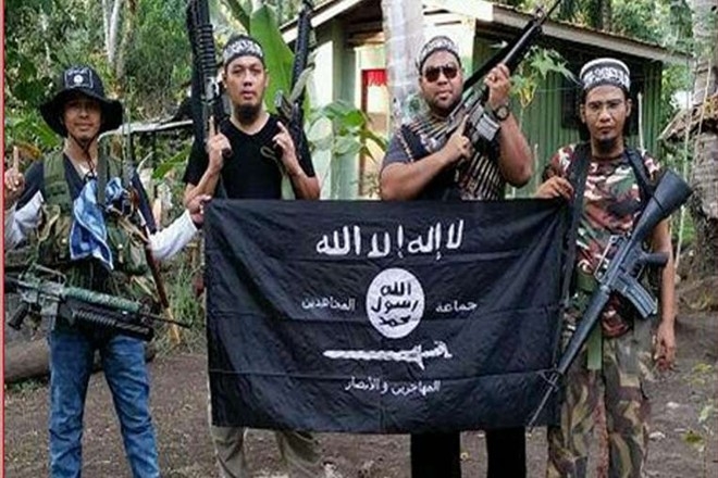 Nh&oacute;m chiến binh Hồi gi&aacute;o người Malaysia khoe cờ của IS tại một địa điểm ở miền nam Philippines. Ảnh:&nbsp;Straits Times