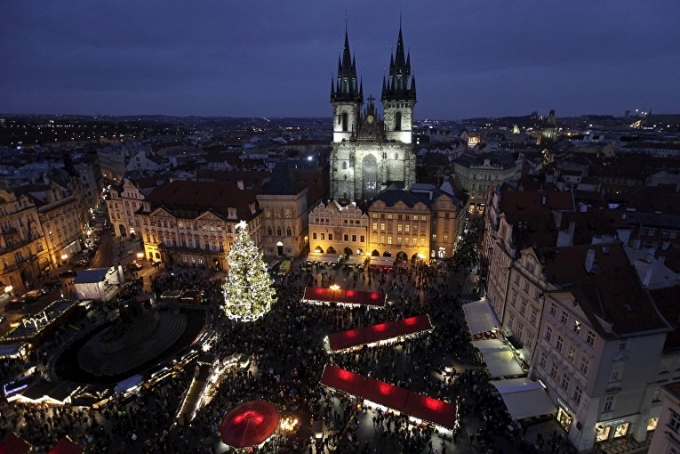 Tại Prague (Cộng h&ograve;a S&eacute;c), một c&acirc;y th&ocirc;ng Noel lớn nằm ngay trong Quảng trường &ldquo;Old Town Square&rdquo;. Ngay cạnh b&ecirc;n l&agrave; những gian h&agrave;ng của một hội chợ gi&aacute;ng sinh truyền thống. (Ảnh: Reuters)