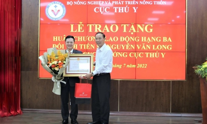 Thứ trưởng Bộ NN-PTNT Phùng Đức Tiến trao Huân chương Lao động hạng Ba cho Quyền Cục trưởng Cục Thú y Nguyễn Văn Long ngày 7/7/2022. Ảnh: Phạm Hiếu.